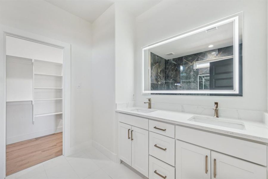 Bathroom with tile patterned flooring and vanity