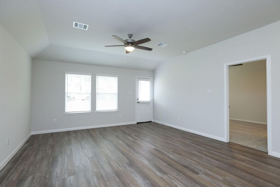 The Family Room with loads of potential decorating options provides access to the backyard and Primary Bedroom.