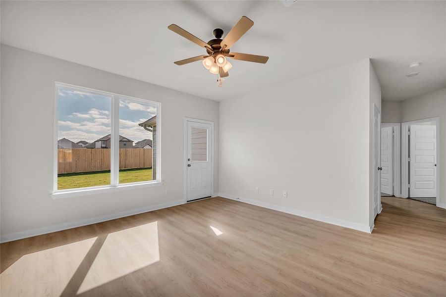 Spare room featuring light wood-style flooring and ceiling fan