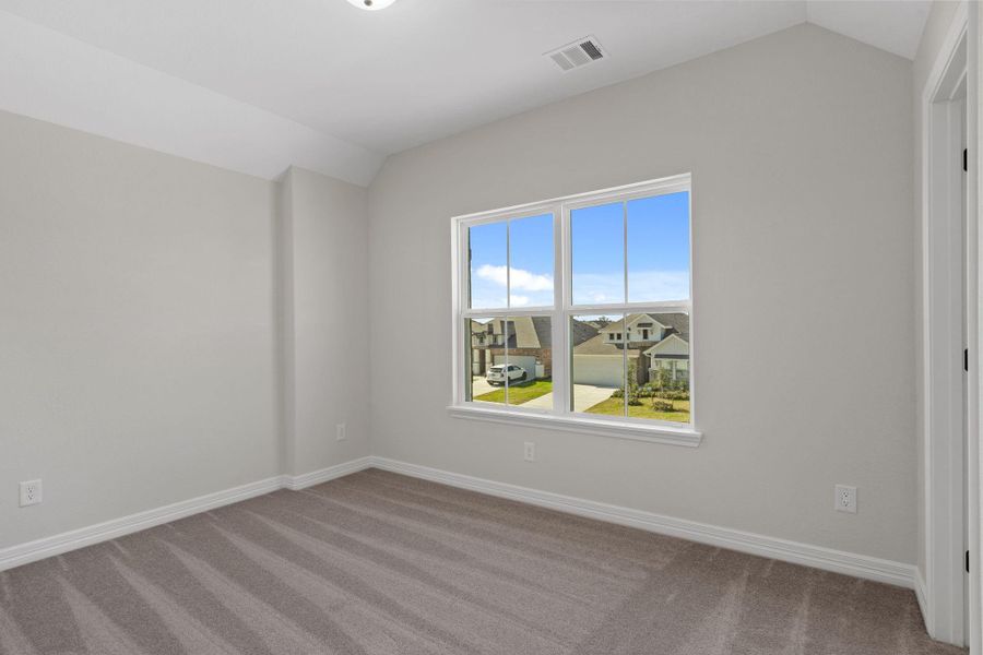 Your secondary bedroom features plush carpet, fresh paint, closet, and a large window that lets in plenty of natural lighting.