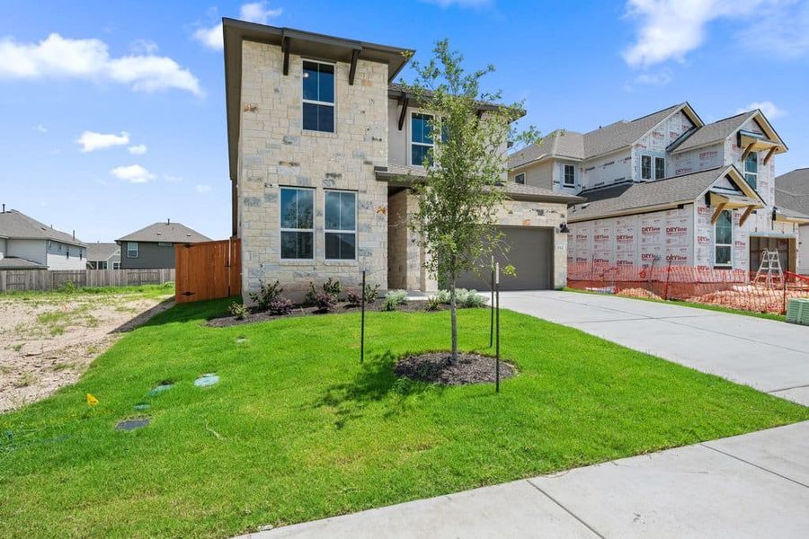 Front exterior of a new home in Lariat, Liberty Hill, TX, highlighting curb appeal (Image 24).