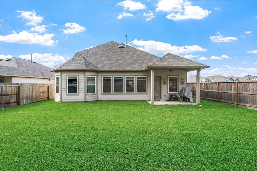 Exterior details and patio area of a home in Pinewood at Grand Texas, New Caney (Image 21).