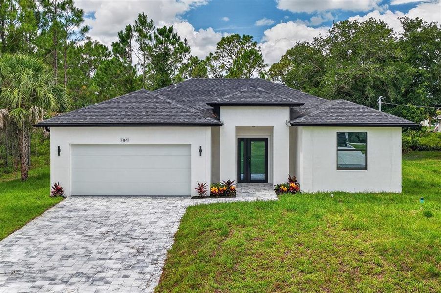 Front exterior of a new home in , North Port, FL, highlighting curb appeal (Image 2). Front exterior of a new home in , North Port, FL, highlighting curb appeal (Image 2).