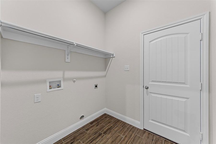 Laundry area with hookup for an electric dryer, gas dryer hookup, and washer hookup