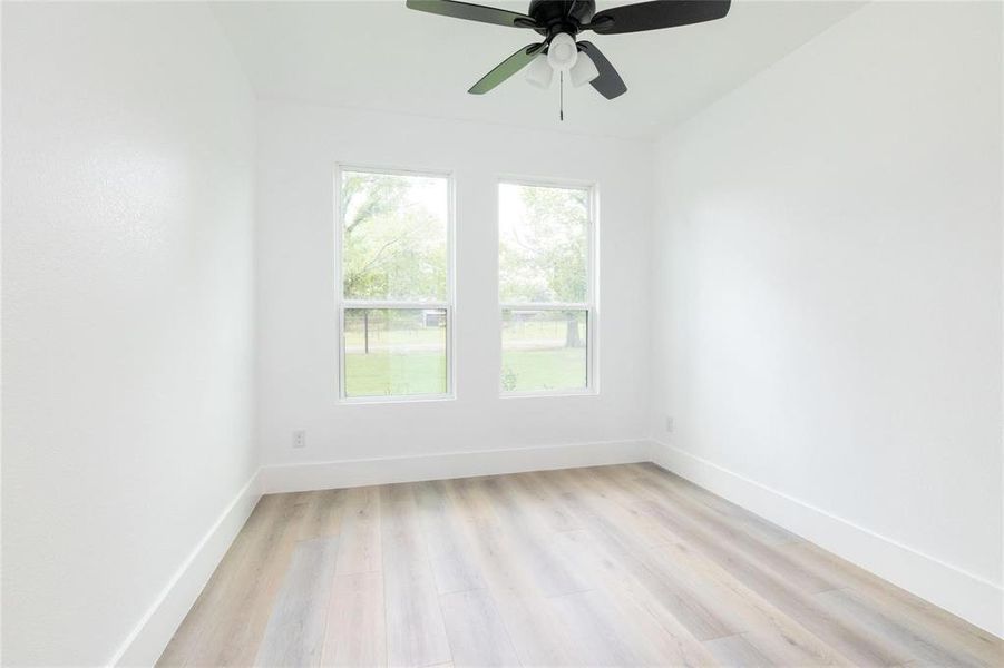 Spare room featuring ceiling fan and light hardwood / wood-style flooring