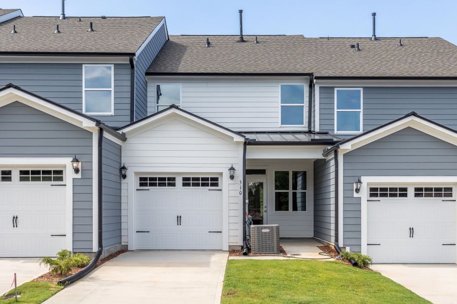 Front exterior of a new home in Enclave at Traditions Townhomes, Wake Forest, NC, highlighting curb appeal (Image 2). Front exterior of a new home in Enclave at Traditions Townhomes, Wake Forest, NC, highlighting curb appeal (Image 2).