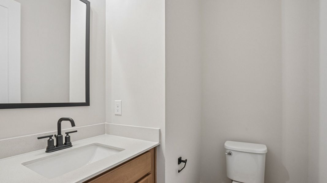 First floor powder room with vanity and toilet