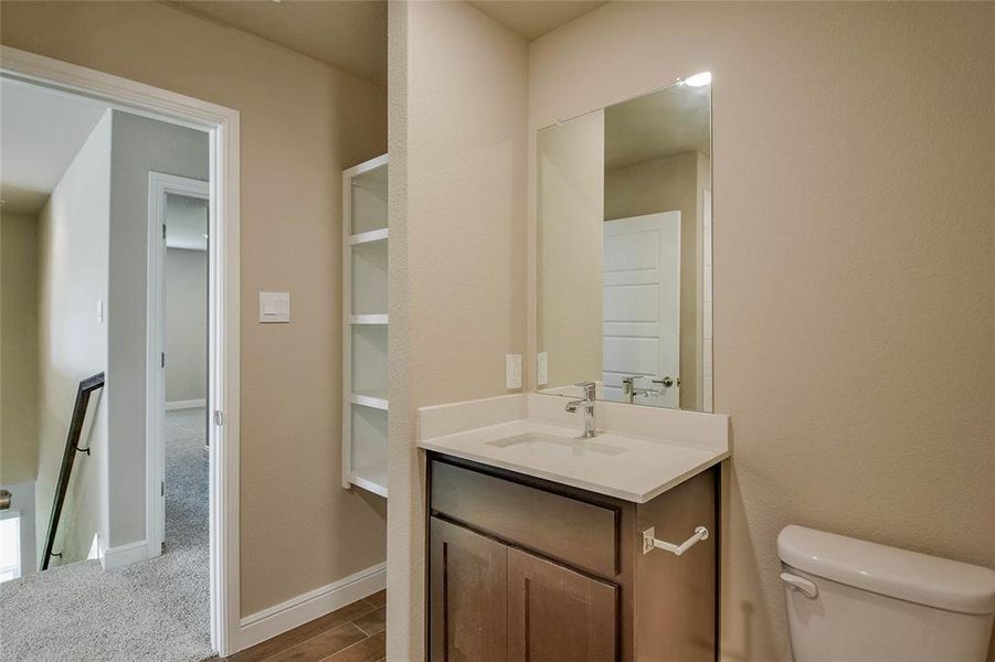 Bathroom featuring vanity and wood finished floors Bathroom featuring vanity and wood finished floors