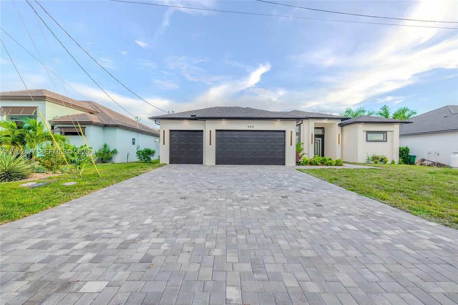 Front exterior of a new home in , Cape Coral, FL, highlighting curb appeal (Image 1). Front exterior of a new home in , Cape Coral, FL, highlighting curb appeal (Image 1).