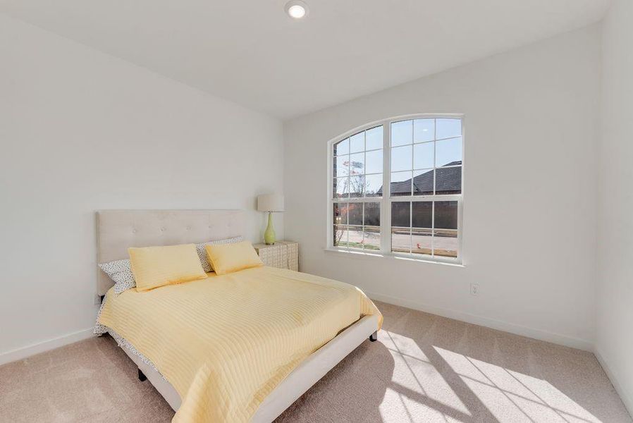 Bedroom featuring light colored carpet and recessed lighting