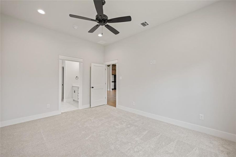 Carpeted room with recessed lighting and a ceiling fan