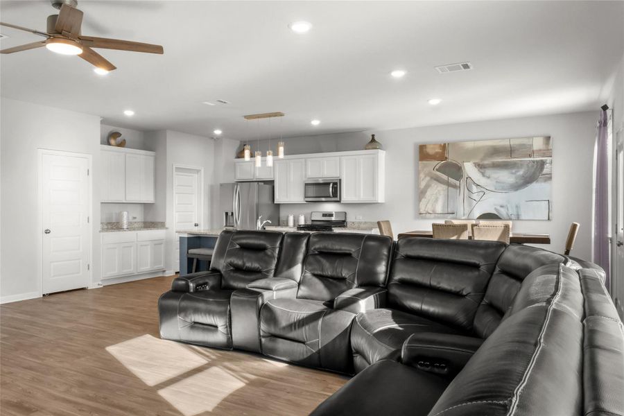 Living area featuring light wood finished floors, recessed lighting, and ceiling fan