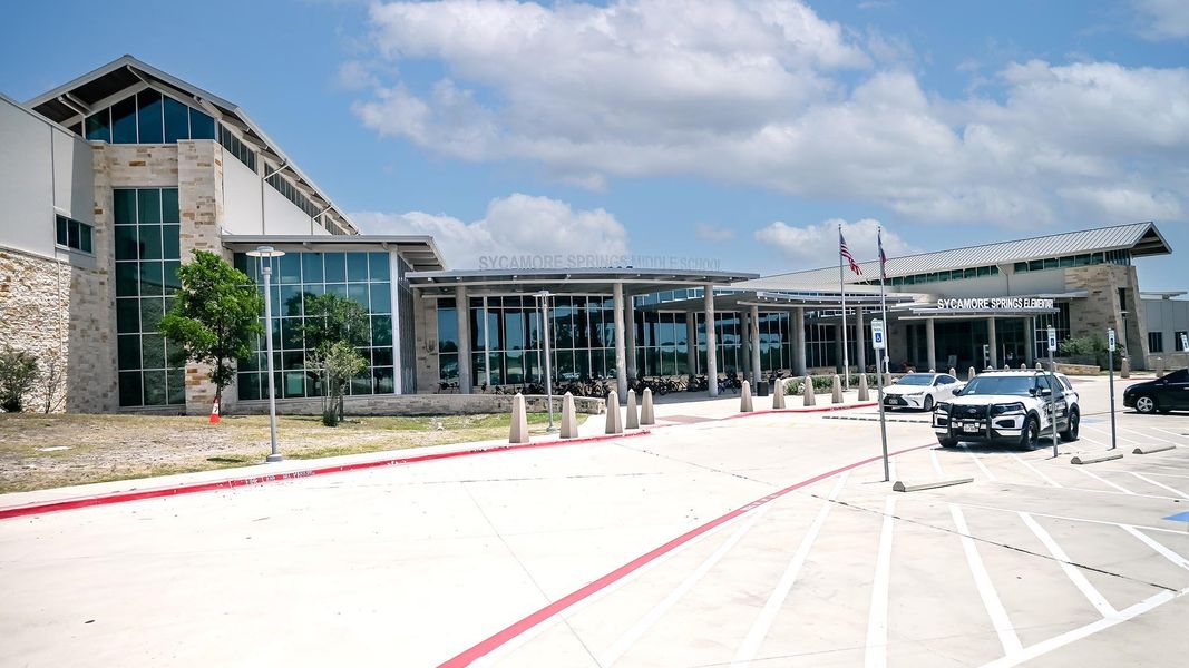 View of property with uncovered parking