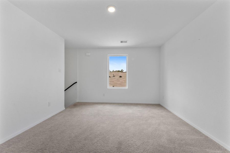 Upstairs gameroom/loft- perfect for movie nights, kids, or flex space.