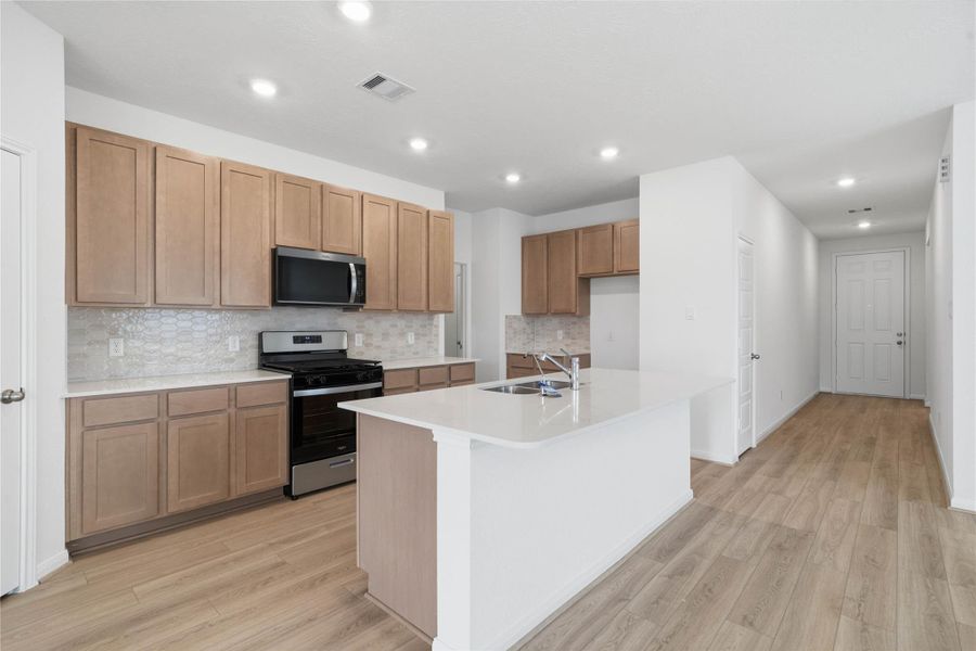 The quartz countertops - Siberian, and the Daltile backsplash is Miramo Picket Mosaic in Silver Grey.