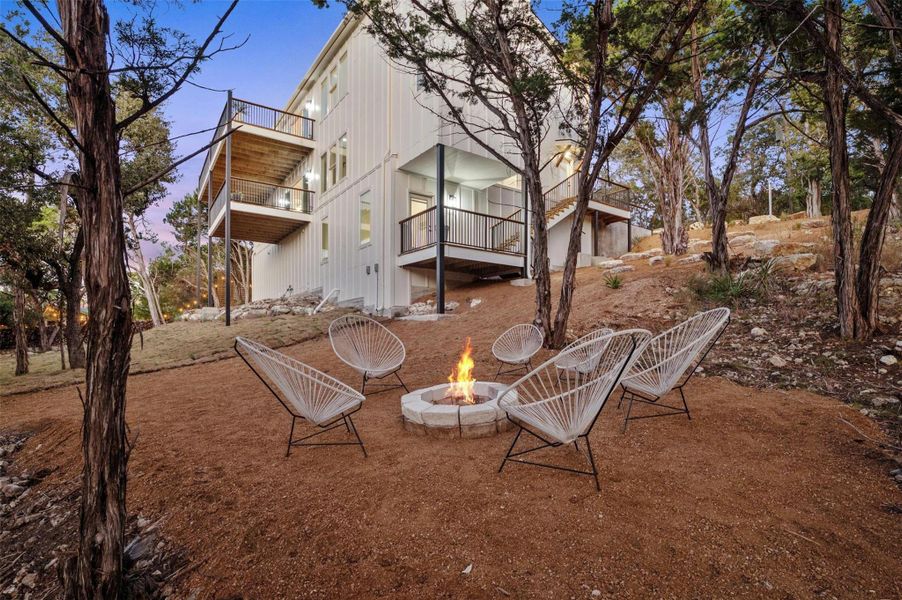 Enjoy the expansive private acreage with xeriscape landscaping and a fire pit area.