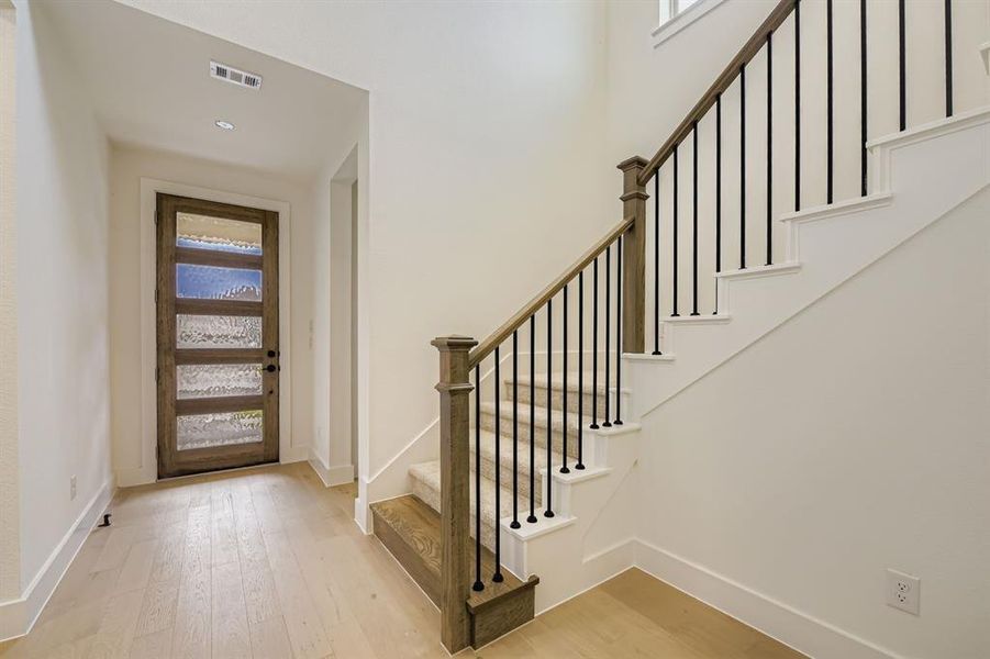 Entryway with light wood-type flooring and stairway Entryway with light wood-type flooring and stairway