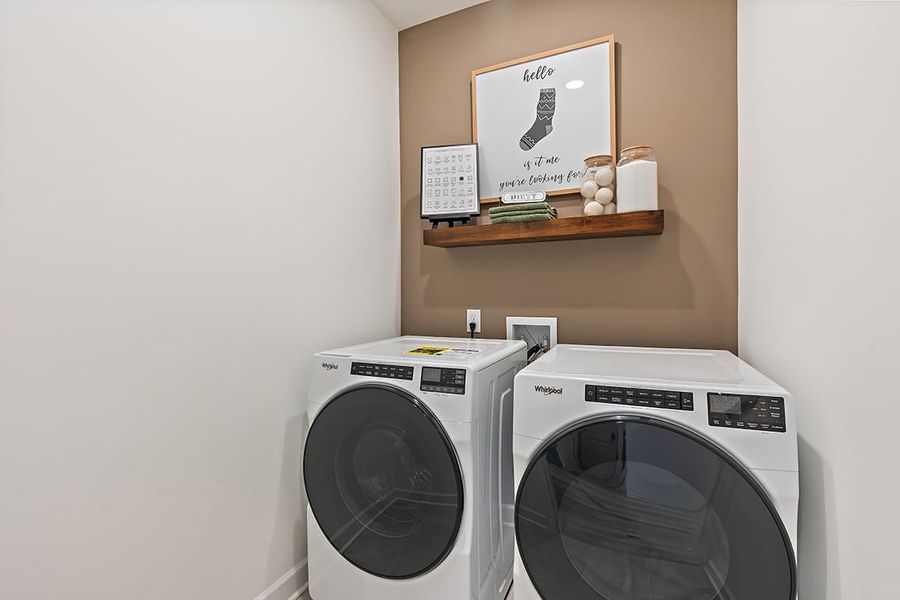 A white washing machine and a shelf. A white washing machine and a shelf.