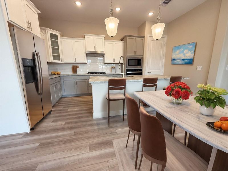 Experience Culinary excellence in the kitchen at Winfrey Estates, where state-of-the-art appliances meet sophisticated design. This gourmet space boasts expansive countertops, stylish cabinetry, and top-of-the-line fixtures, creating an ideal environment for both casual meals and lavish entertaining. *Image is virtually staged and depicts similar floorplan in the community. Experience Culinary excellence in the kitchen at Winfrey Estates, where state-of-the-art appliances meet sophisticated design. This gourmet space boasts expansive countertops, stylish cabinetry, and top-of-the-line fixtures, creating an ideal environment for both casual meals and lavish entertaining. *Image is virtually staged and depicts similar floorplan in the community.