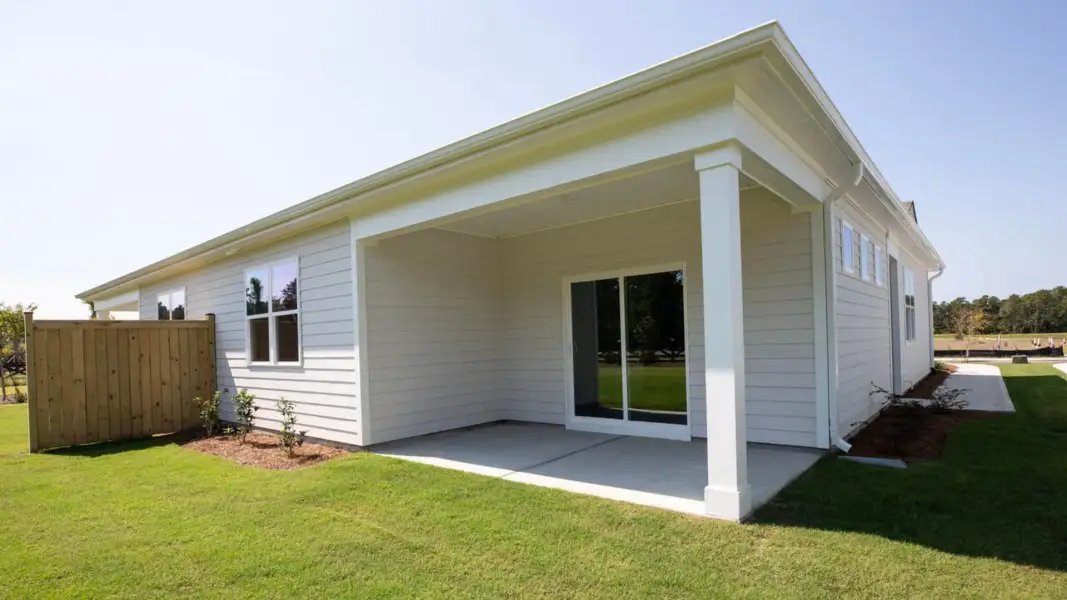 Exterior details and patio area of a home in The Retreat at Indigo Preserve Townhomes, Leland (Image 17).