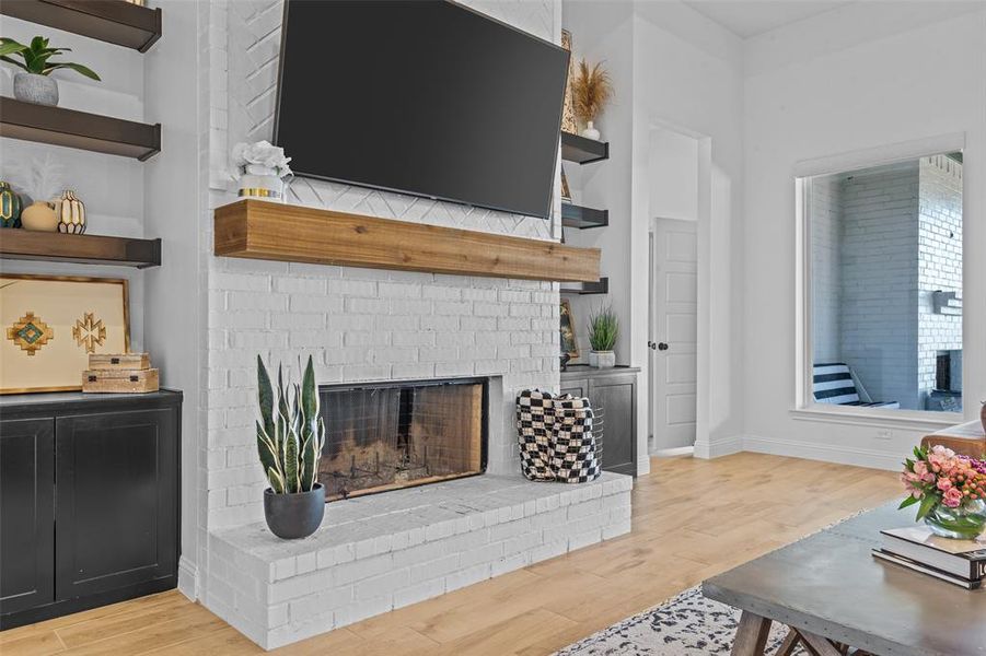 Living room featuring a fireplace and light hardwood / wood-style flooring