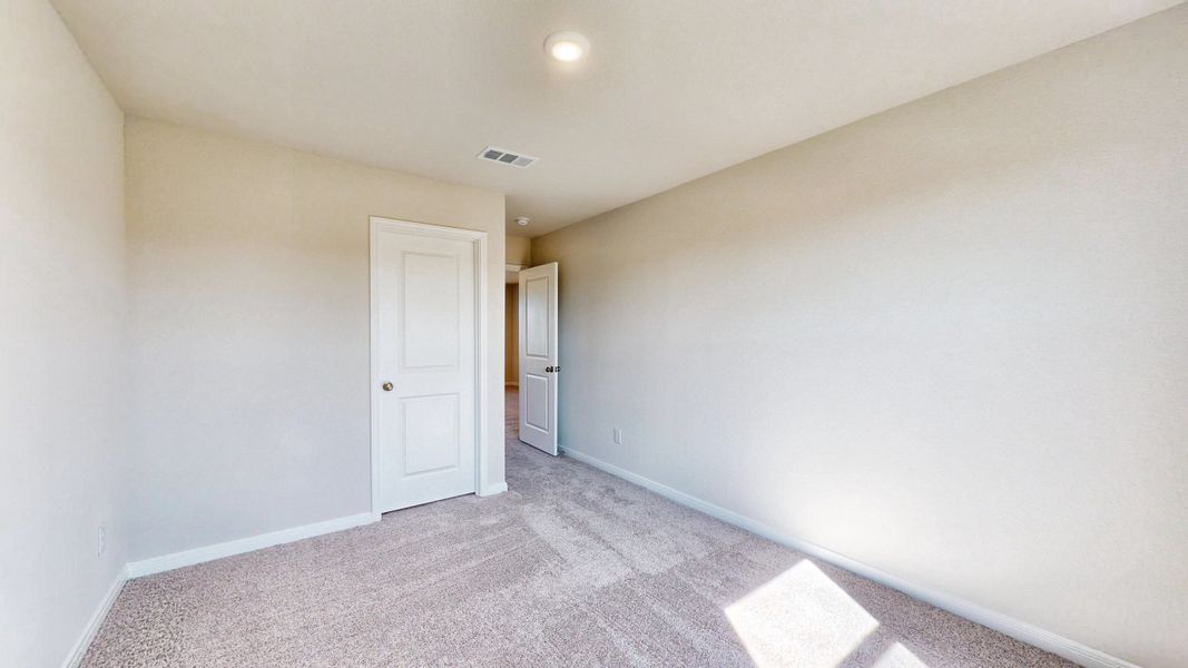 A hallway with white walls.