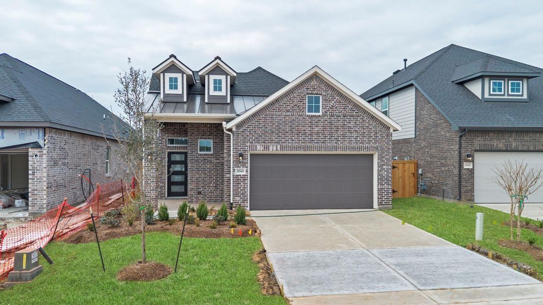 Front exterior of a new home in Emory Glen, Magnolia, TX, highlighting curb appeal (Image 2). Front exterior of a new home in Emory Glen, Magnolia, TX, highlighting curb appeal (Image 2).