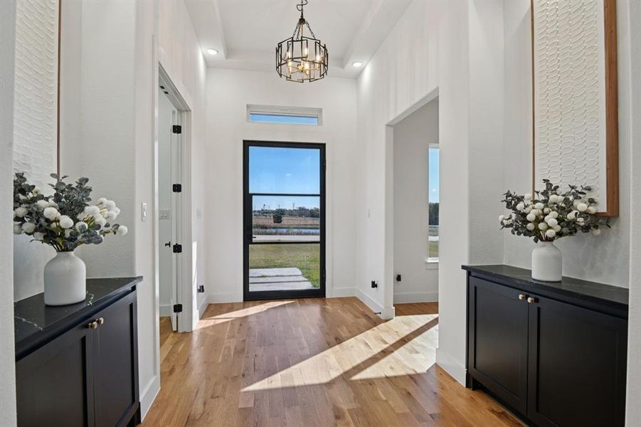 Foyer with light wood-style flooring, a chandelier, and recessed lighting Foyer with light wood-style flooring, a chandelier, and recessed lighting
