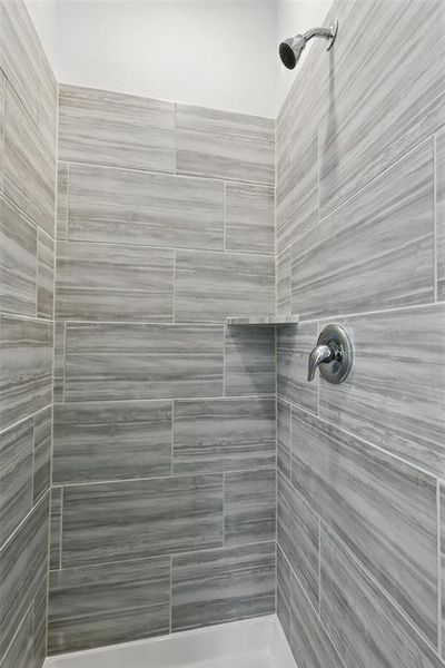 Full bathroom with a tile shower Full bathroom with a tile shower