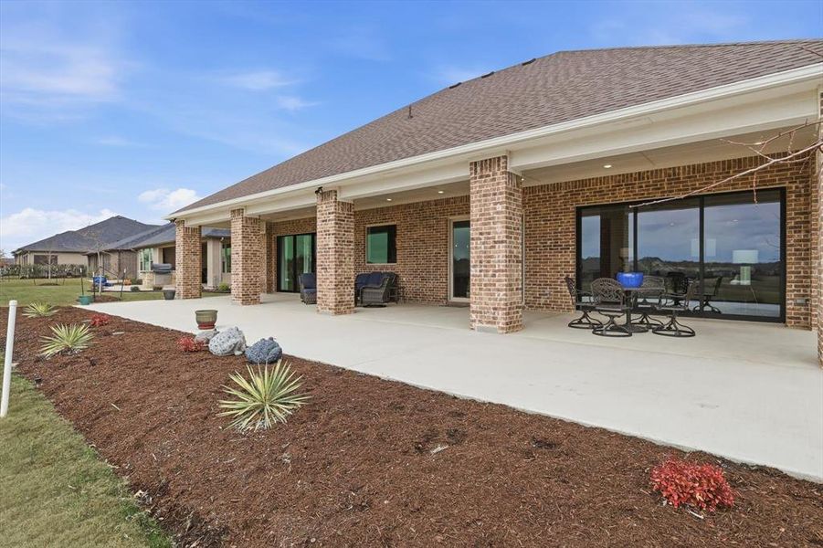 Spectacular Expanded Outdoor Living Pavilion with Prized Southern Exposure and commanding Panoramic Fairway Views from Tee to Green. Grand in scale, this Exceptional Space Accommodates Multiple Lounge and Entertaining Settings while delivering a True Resort-Style Experience at Home. Accessed from Great Room, Dining Area, and Primary Suite.