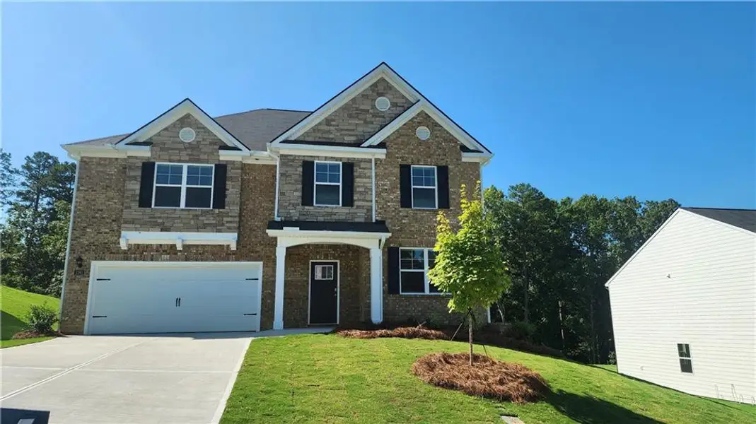 Front exterior of a new home in Brooks Station, Dacula, GA, highlighting curb appeal (Image 1). Front exterior of a new home in Brooks Station, Dacula, GA, highlighting curb appeal (Image 1).