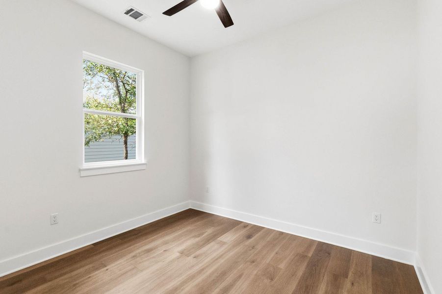 A well-lit room offers ample natural light and durable hardwood-style flooring. A well-lit room offers ample natural light and durable hardwood-style flooring.
