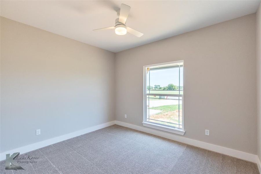 Spare room with light carpet and ceiling fan
