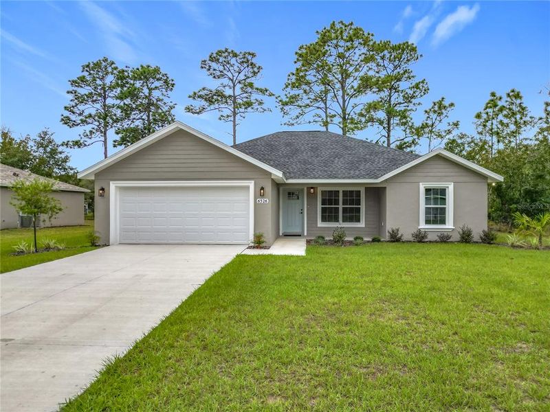 Front exterior of a new home in , Citrus Springs, FL, highlighting curb appeal (Image 27). Front exterior of a new home in , Citrus Springs, FL, highlighting curb appeal (Image 27).