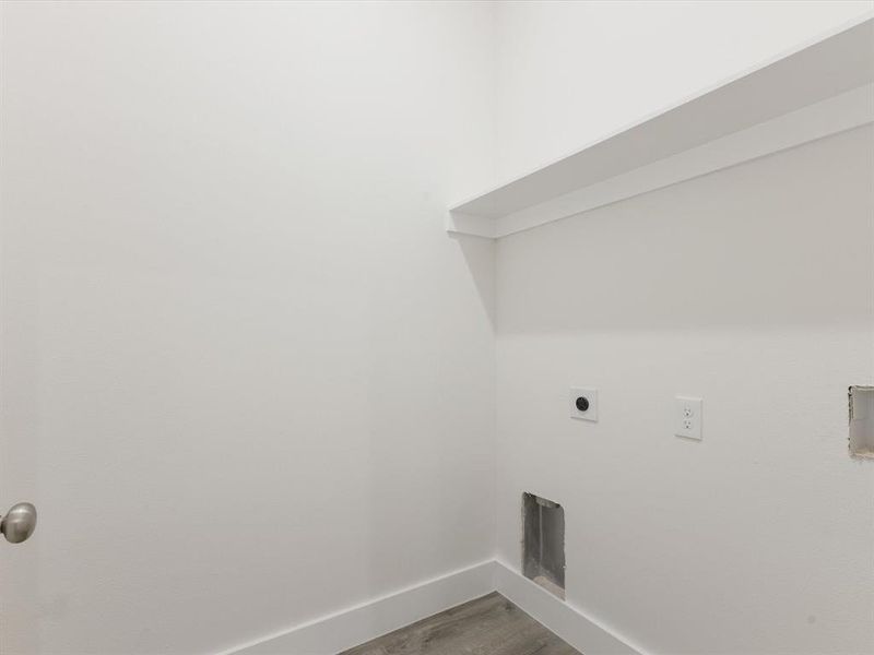 Washroom with light wood-style floors and electric dryer hookup