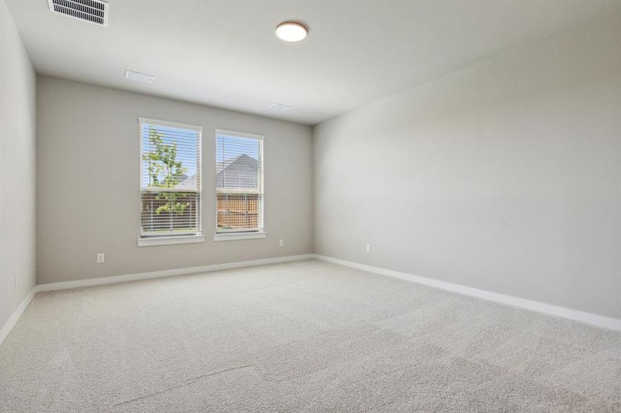 Primary bedroom in the Masters home plan by Trophy Signature Homes – REPRESENTATIVE PHOTO