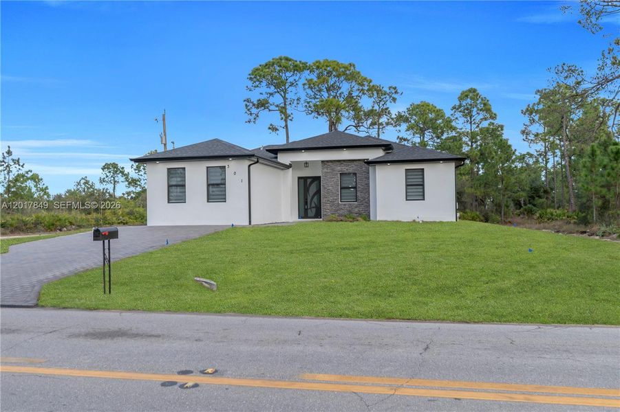 Front exterior of a new home in , Lehigh Acres, FL, highlighting curb appeal (Image 25).