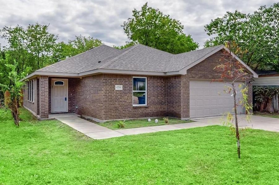 Ranch-style house with a front lawn and a garage