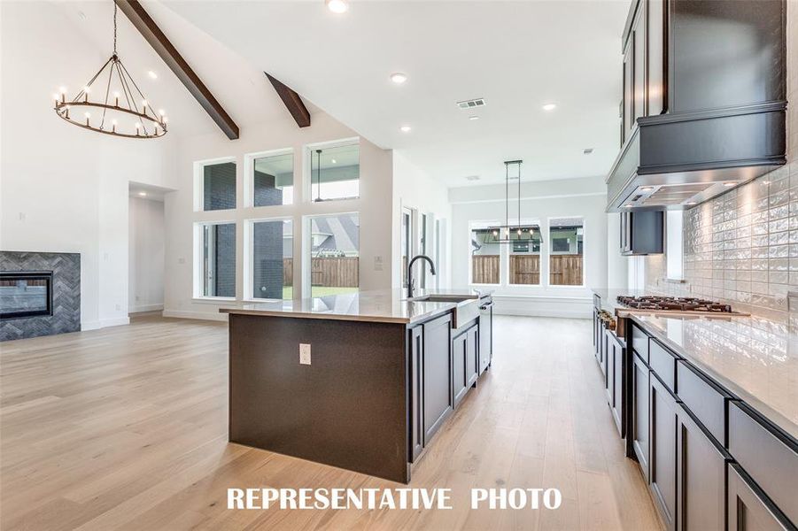 With the kitchen open to the dining and family rooms, this home was designed for entertaining!  REPRESENTATIVE PHOTO