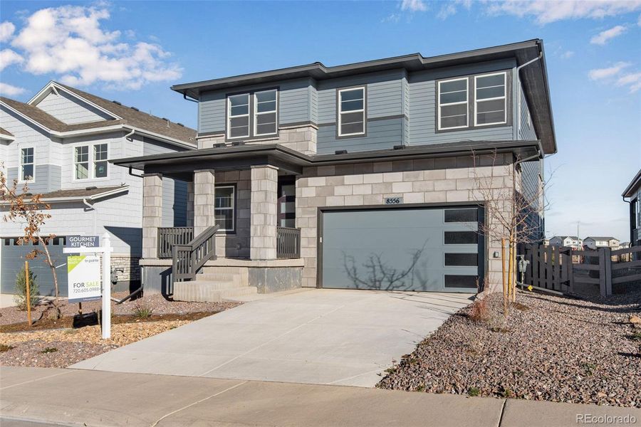Front exterior of a new home in Prelude at Sterling Ranch, Littleton, CO, highlighting curb appeal (Image 28).