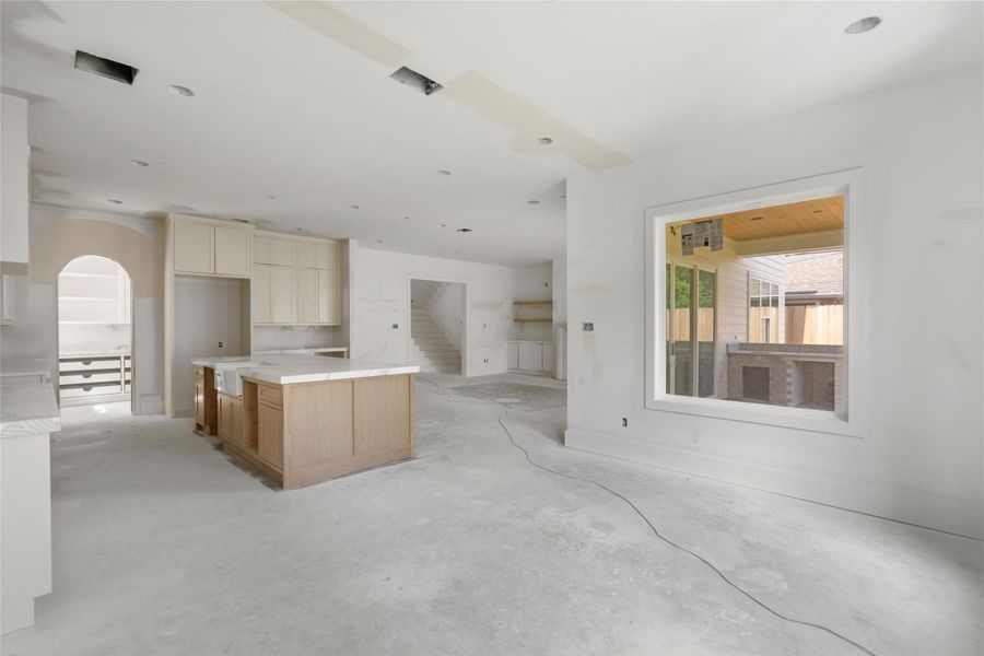 Another angle showing view from dining space looking onto kitchen and living area. Notice the arched entrance for pantry/dirty kitchen area. Another angle showing view from dining space looking onto kitchen and living area. Notice the arched entrance for pantry/dirty kitchen area.