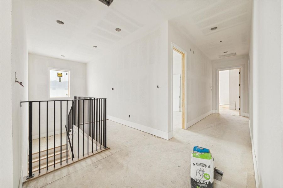 A thoughtfully designed upper level landing anchored by clean lines and custom iron railing detail. Flooded with natural light and surrounded by well proportioned secondary rooms, this transitional space enhances the home’s architectural presence while offering additional flexibility for everyday living. A thoughtfully designed upper level landing anchored by clean lines and custom iron railing detail. Flooded with natural light and surrounded by well proportioned secondary rooms, this transitional space enhances the home’s architectural presence while offering additional flexibility for everyday living.