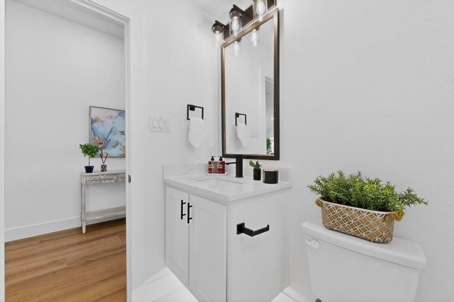 Hall bathroom featuring vanity and light wood-style flooring Hall bathroom featuring vanity and light wood-style flooring