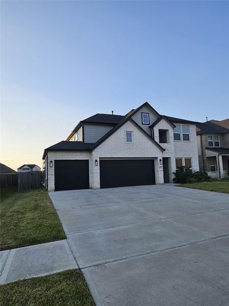 Front exterior of a new home in Briarwood Crossing, Rosenberg, TX, highlighting curb appeal (Image 2). Front exterior of a new home in Briarwood Crossing, Rosenberg, TX, highlighting curb appeal (Image 2).