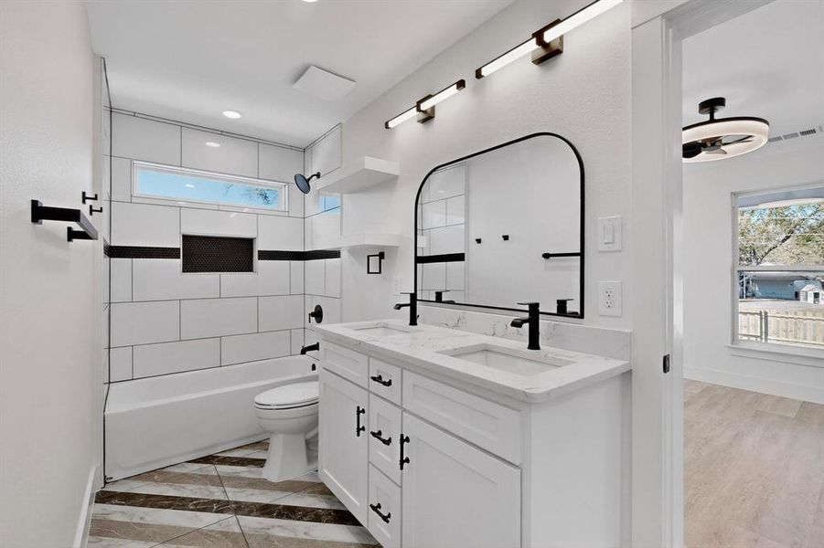 Full bathroom with shower / washtub combination and double vanity