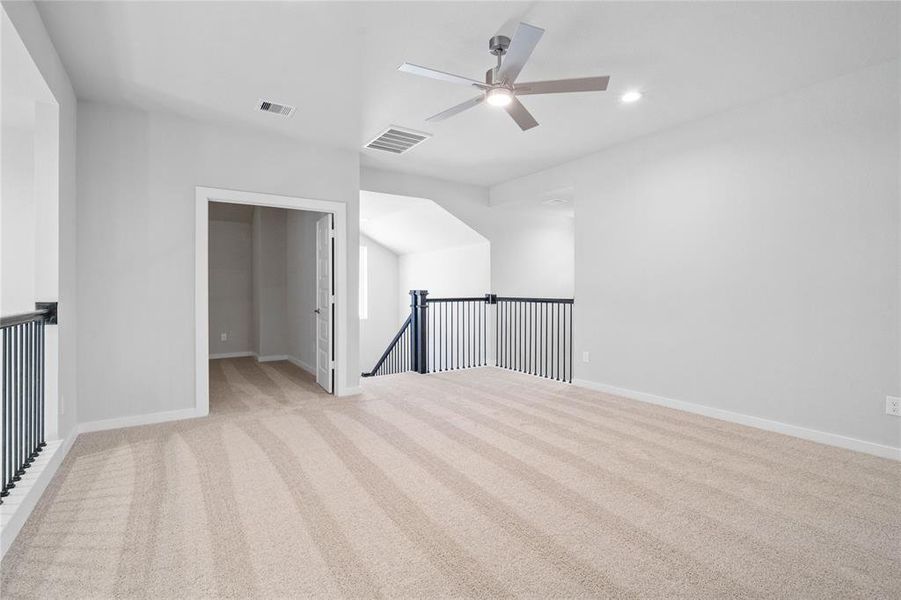 Another view of the game room looking into the media room entrance and the staircase.