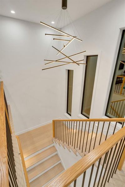 Staircase with wood finished floors and recessed lighting Staircase with wood finished floors and recessed lighting