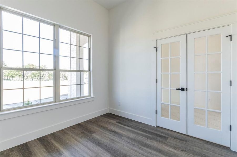 Unfurnished room featuring dark wood-type flooring