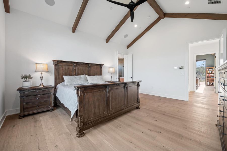 Bedroom with light wood-style flooring, high vaulted ceiling, baseboards, and beamed ceiling Bedroom with light wood-style flooring, high vaulted ceiling, baseboards, and beamed ceiling