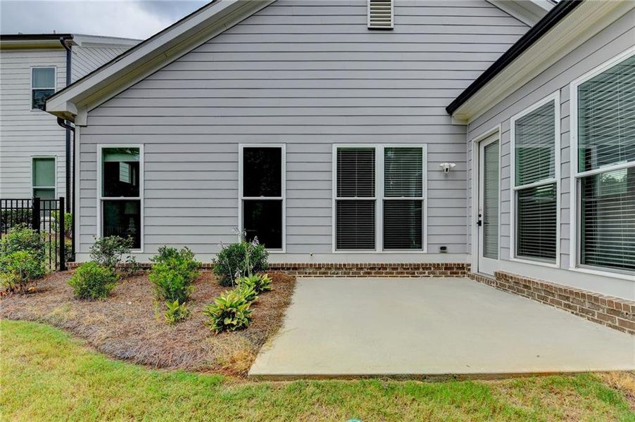 Exterior details and patio area of a home in Ellington Townhomes, Suwanee (Image 4).
